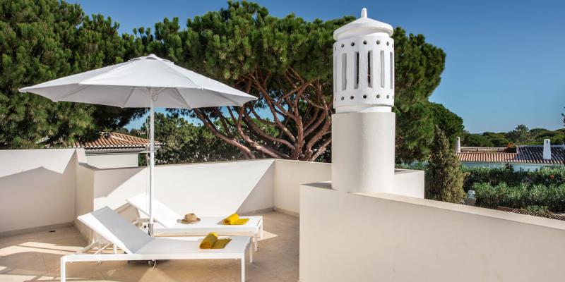 The private terrace outside Vlla Florabella in Portugal with distant sea views