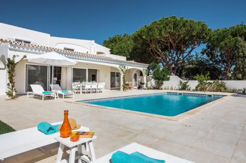 Enjoy a drink by the pool at our private villa