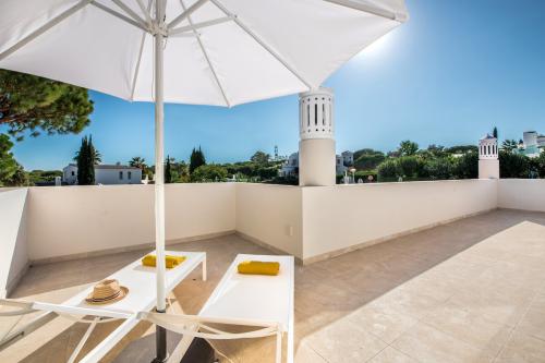 Terrace with sun loungers and distant sea views